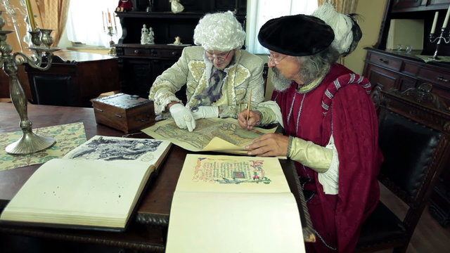 Mayor and scholar talking about an old map figuring out where to go