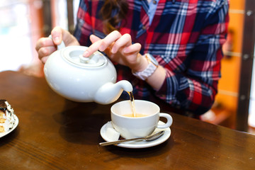 female hands poured green tea close up