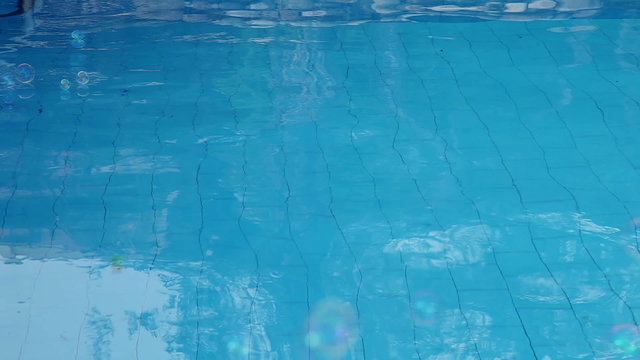 Falling down soap bubbles at pool