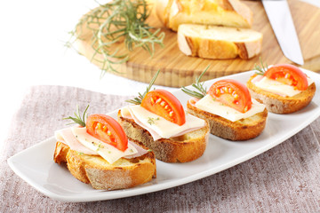 Bruschetta with tomato, ham and cheese