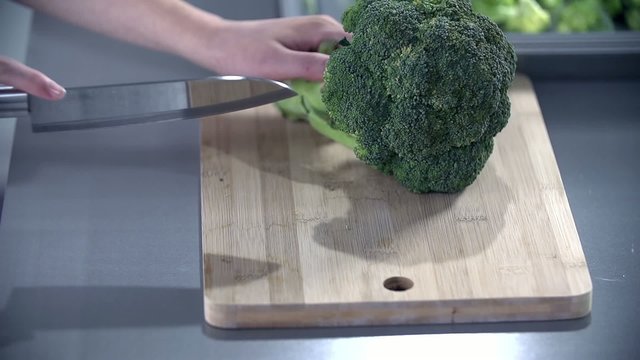 Slicing broccoli on a wooden desk