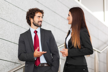 Two business people discussing outdoor