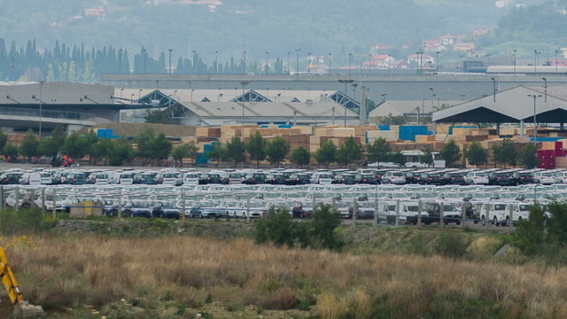 KOPER, SLOVENIA - SEP 15, 2013: Pan shot of countless cars in front of car factory
