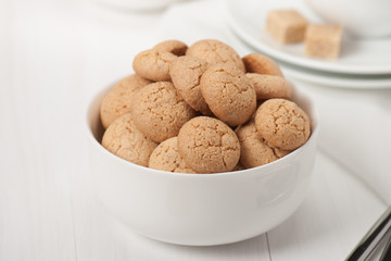 Amaretti Biscuits. Kitchenware. White Wooden Table