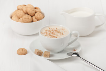Amaretti Biscuits. Cup Of Cappuccino Coffee. Lump Demerara Sugar