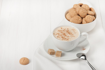 Amaretti Biscuits. Cup Of Cappuccino Coffee. Lump Demerara Sugar