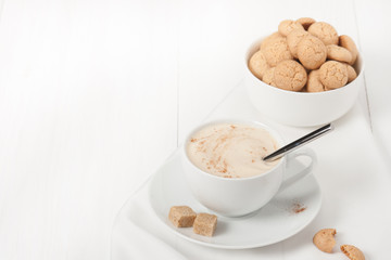 Amaretti Biscuits. Cup Of Cappuccino Coffee. Lump Demerara Sugar