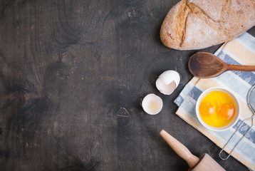 Fototapeta na wymiar Baking background with eggshell, bread, flour, rolling pin