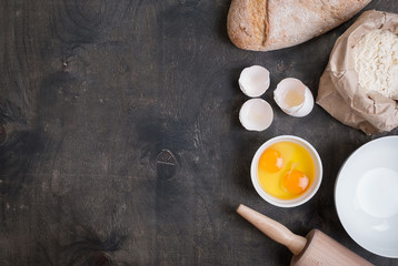 Baking background with eggshell, bread, flour, rolling pin