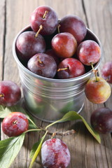 group of fresh plums on wood background