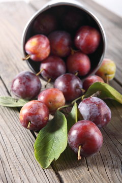 group of fresh plums on wood background