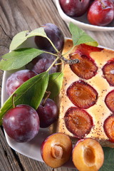 Plum cake over natural wood background