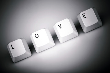 text love formed with computer keyboard keys on white background