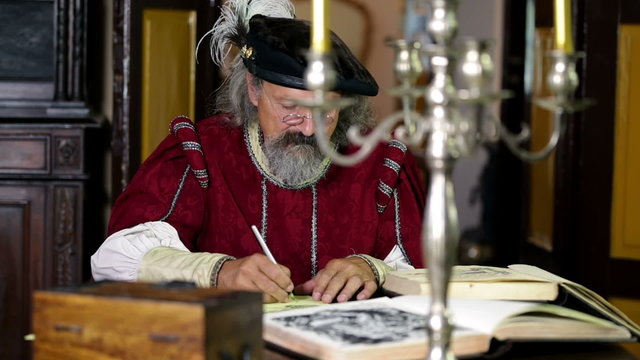 19th century scholar talking and writing something down