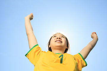 Portrait of young Asian girl with soccer ball.