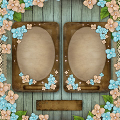 Blue wooden background with 2 vintage frames, flowers, pearls an