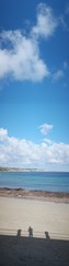 Obraz na płótnie Canvas Tranquil Beach Under Blue Sky Above