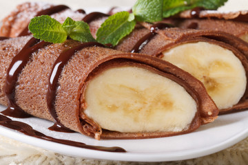 Chocolate crepes with banana filling macro horizontal