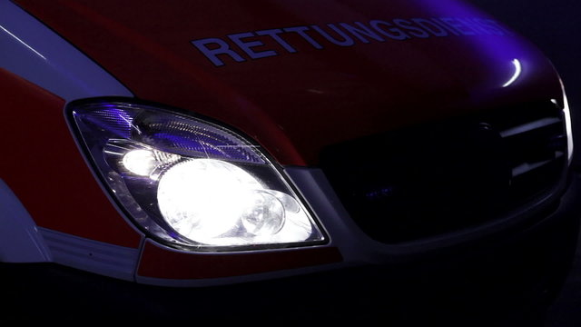 German ambulance truck, sirens and headlight at night.