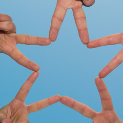 Five people engaged in hand with an asterisk