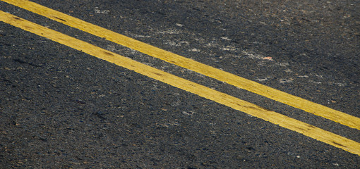 Asphalt dark texture with yellow lines