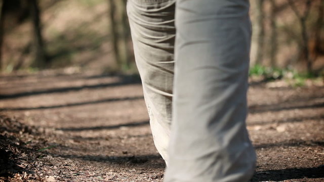 Shot of man's leg walking on the forest path