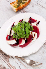 Delicious salad with beet, goat cheese and arugula.