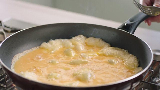 Scrambled eggs preparation in slow motion