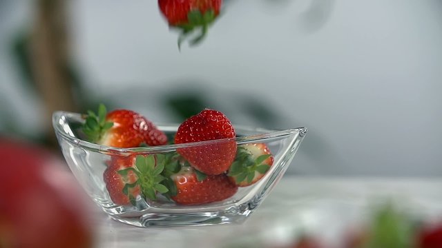 Strawberries fill up the glass cup
