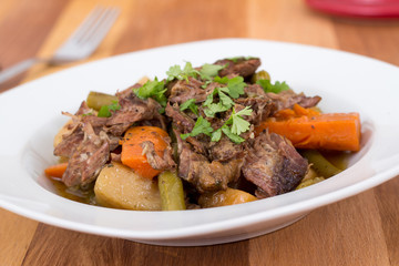 braised beef pot roast stew with vegetables on table