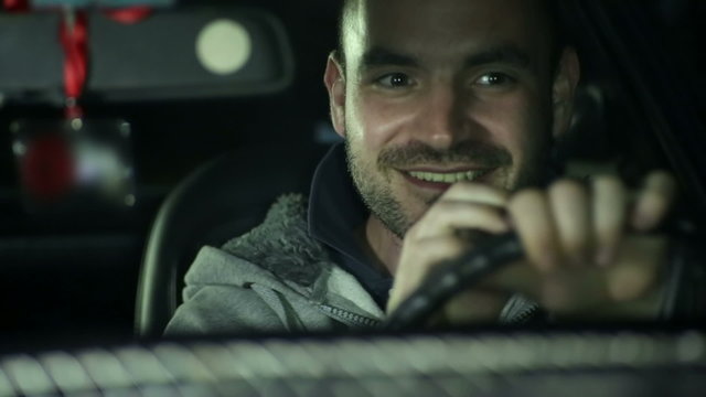 Man driving car with a smile on his face