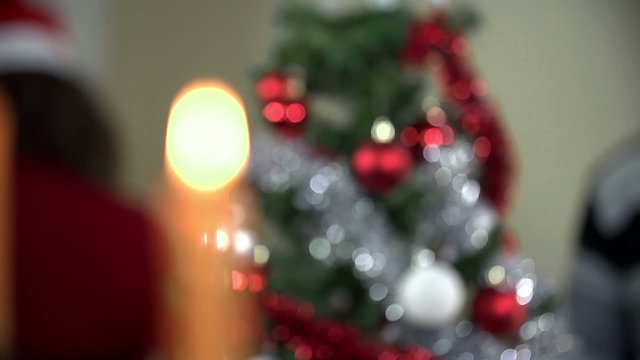 Candlestick refocus to Christmas tree close up