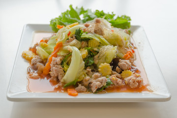 Spicy pork salad on white plate