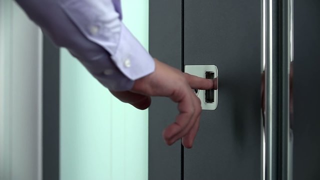 Person in white shirt rings on a doorbell 
