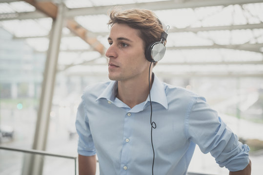 young model hansome blonde man with headphones