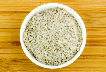 Aerial of healthy chia seed porridge in bowl on wooden backgroun