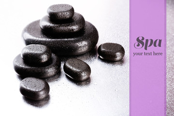 Spa stones with drops on light background