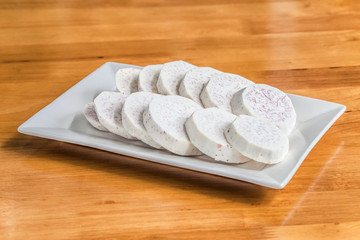 Taro slice on rectangle dish over the wooden table