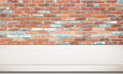 Empty white wooden table over brick wall.