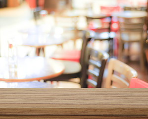 Empty wood table and blurred cafe with bokeh light background