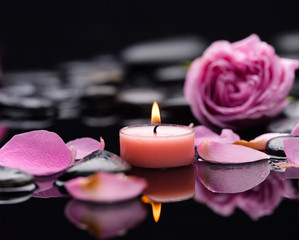 Pink rose with candle ,petals  and therapy stones