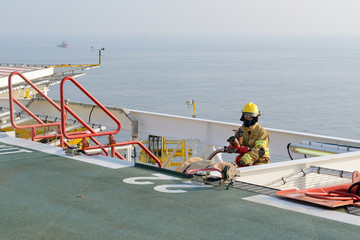 fireman is guarding for offshore helicopter before start up engi
