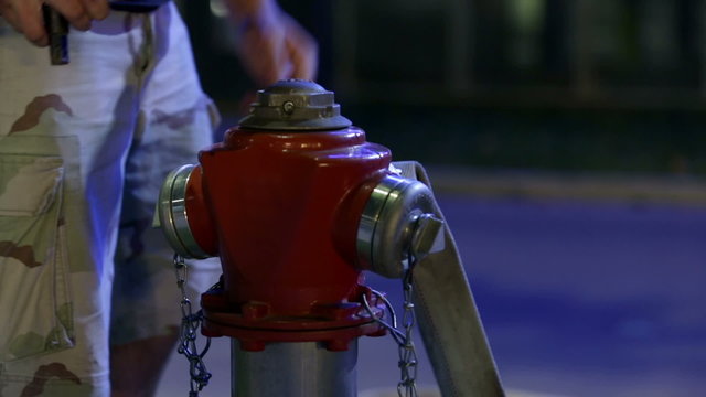 Man loosening the hydrant with the tools