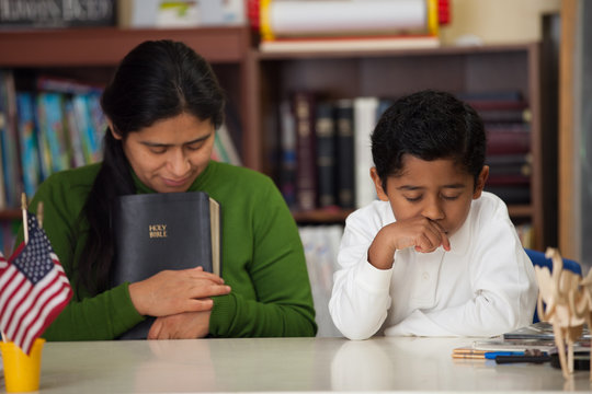 HIspanic Mom and Boy in Homeschool Setting During Worship
