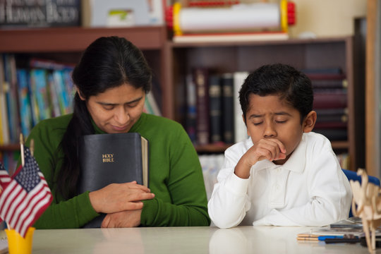HIspanic Mom and Boy in Homeschool Setting During Worship