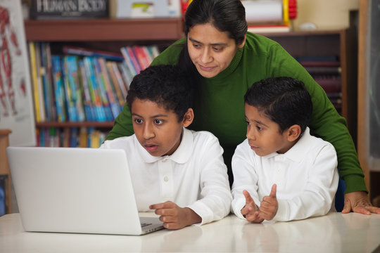 Hispanic Family with Laptop in Homeschool Setting
