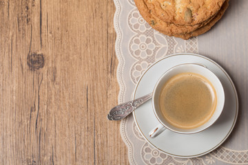 Top view on cup of coffee and plate with cookies