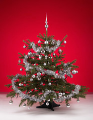 Decorated christmas tree on red background