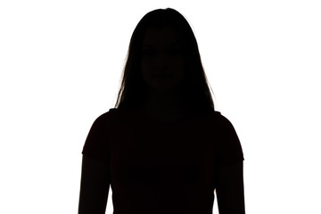 Silhouette of teenager looking at camera