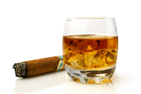 whiskey with ice cubes and  cigar